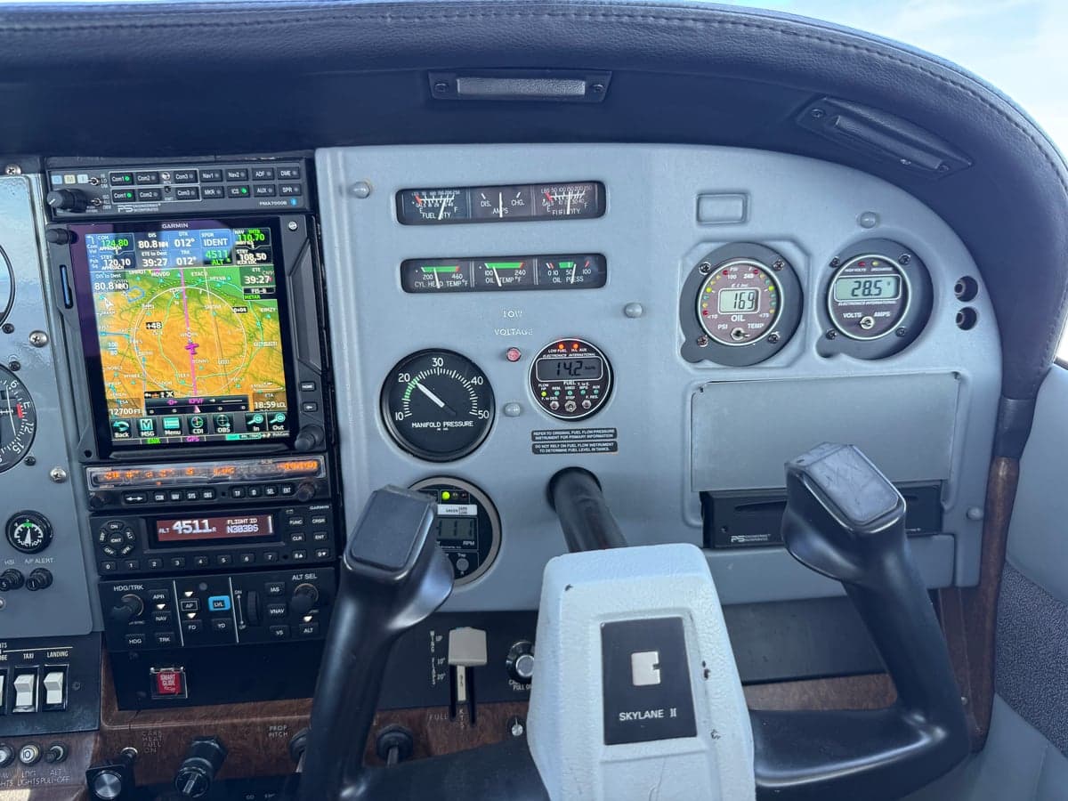 Wide view of the instrument panel and yoke in the cockpit of N303BS.