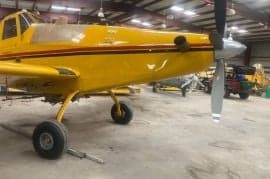 Close-up of the front of a yellow agricultural aircraft.