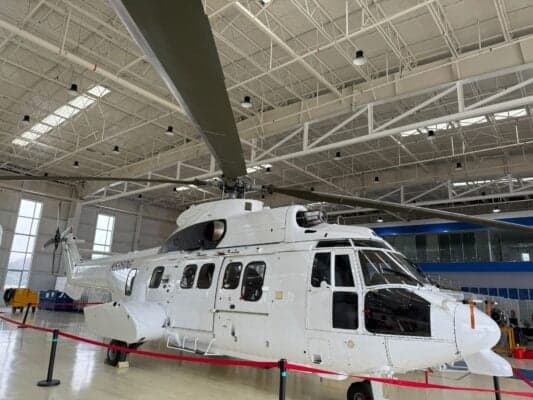 A Eurocopter AS332 Super Puma helicopter with registration N535DG is parked inside a hangar.