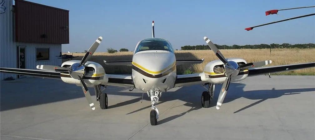 Front view of a Beechcraft Baron on the ground.