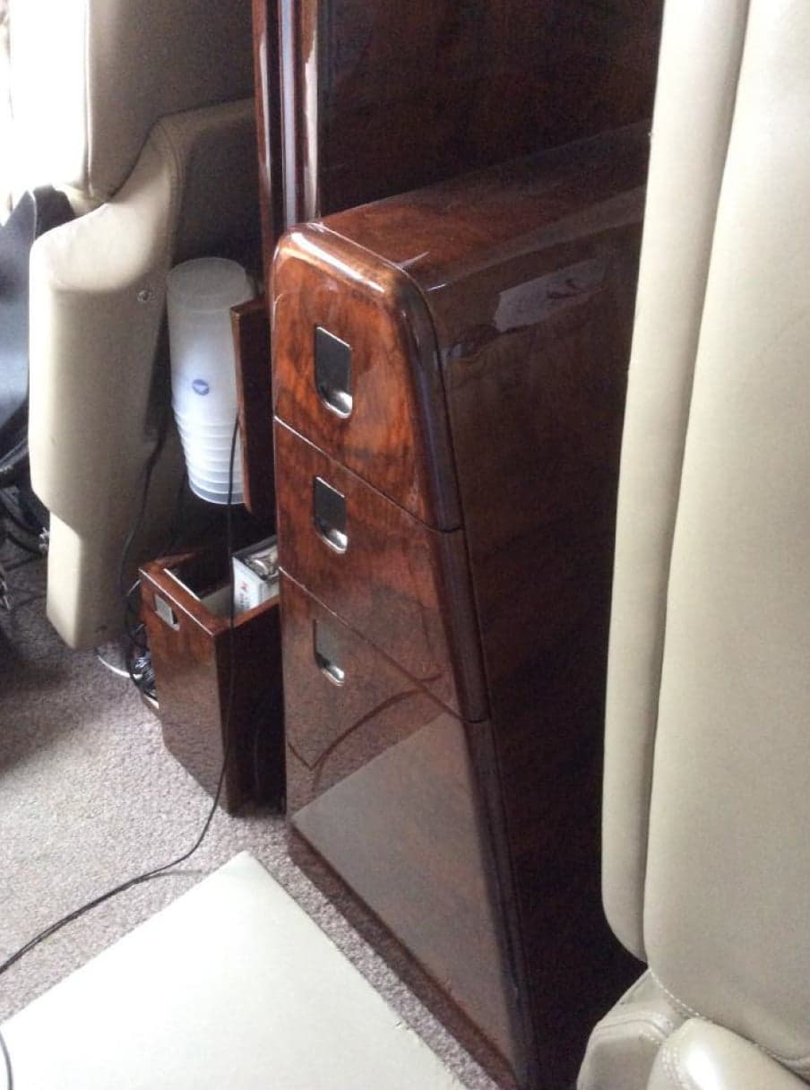 Close-up of the wooden cabinet in the aircraft cabin.
