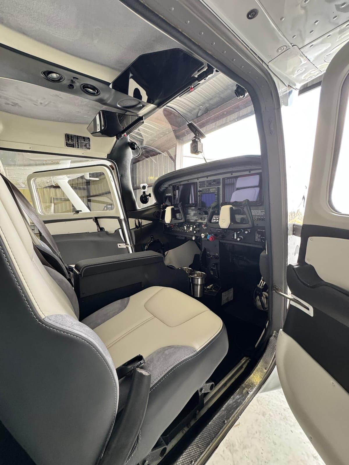 View of the interior of the aircraft, showing the seats and cockpit.