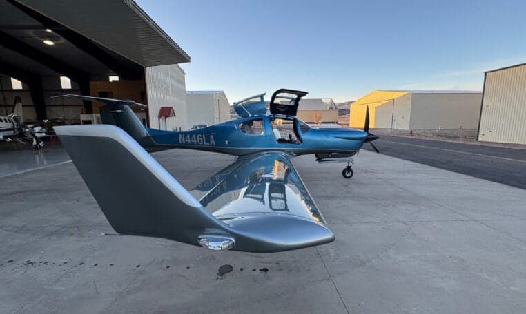 Diamond DA50 RG aircraft N446LA parked on the tarmac with a hangar in the background.