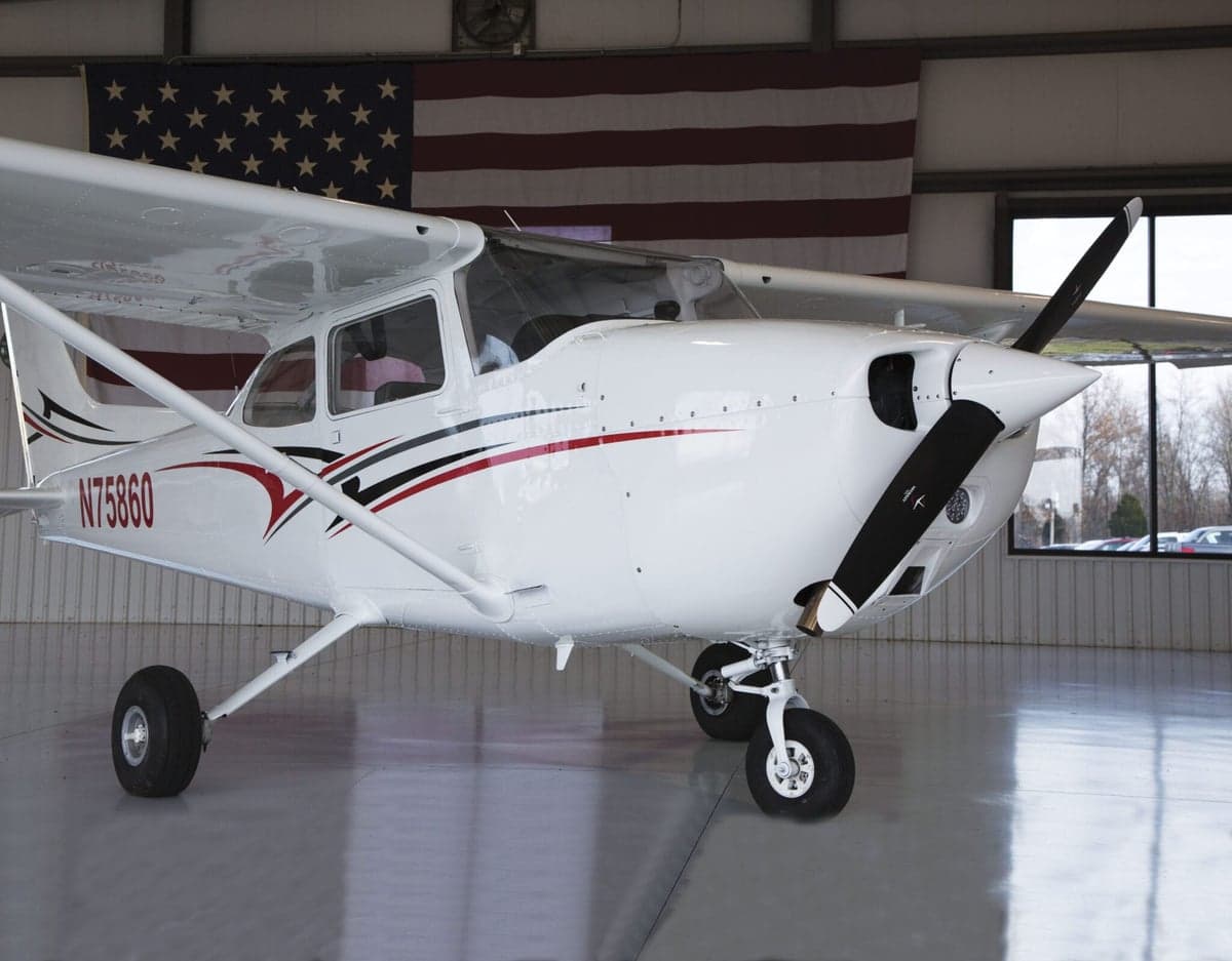 Close-up of a Cessna 172 Skyhawk with a white and red paint scheme.