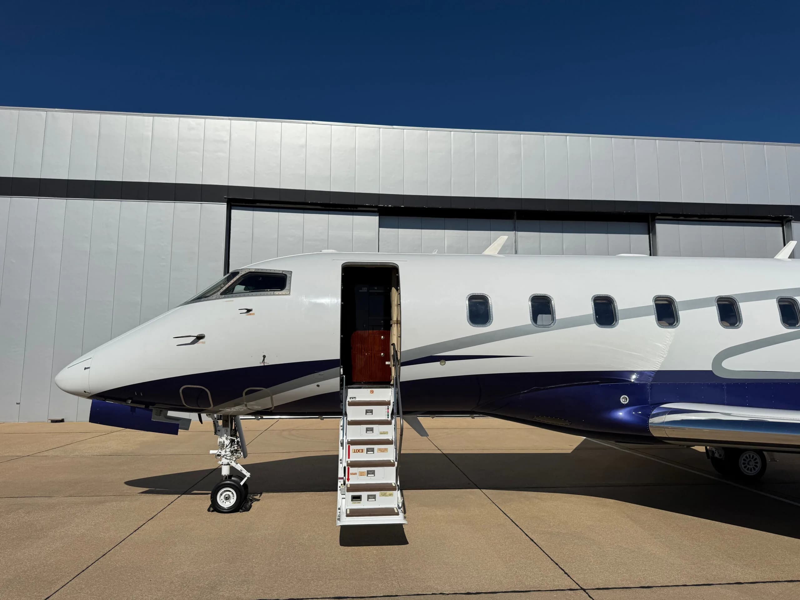 Side view of the N5L business jet with its main cabin door open and integrated stairs extended.