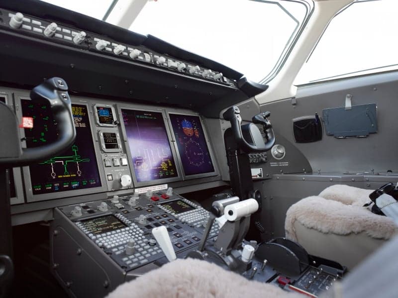 The cockpit of the aircraft features a modern instrument panel and controls.