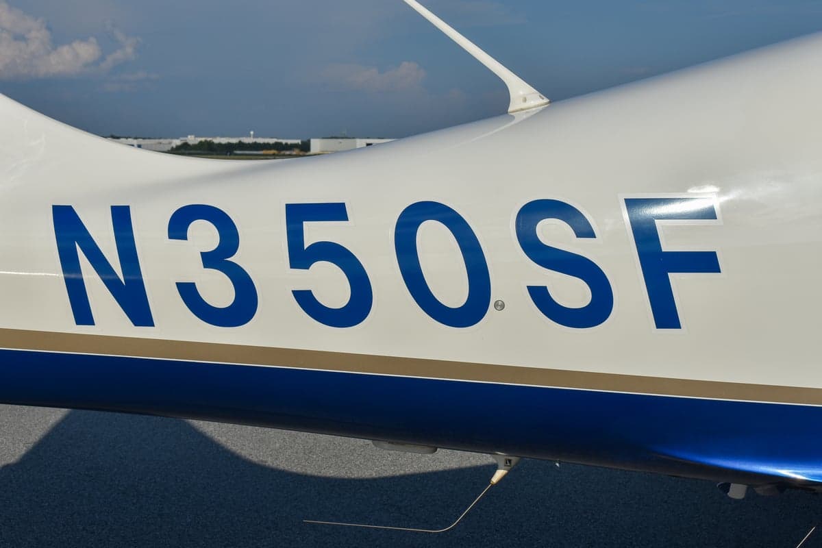 Close-up of the Lancair Columbia 350 logo on the aircraft's exterior.
