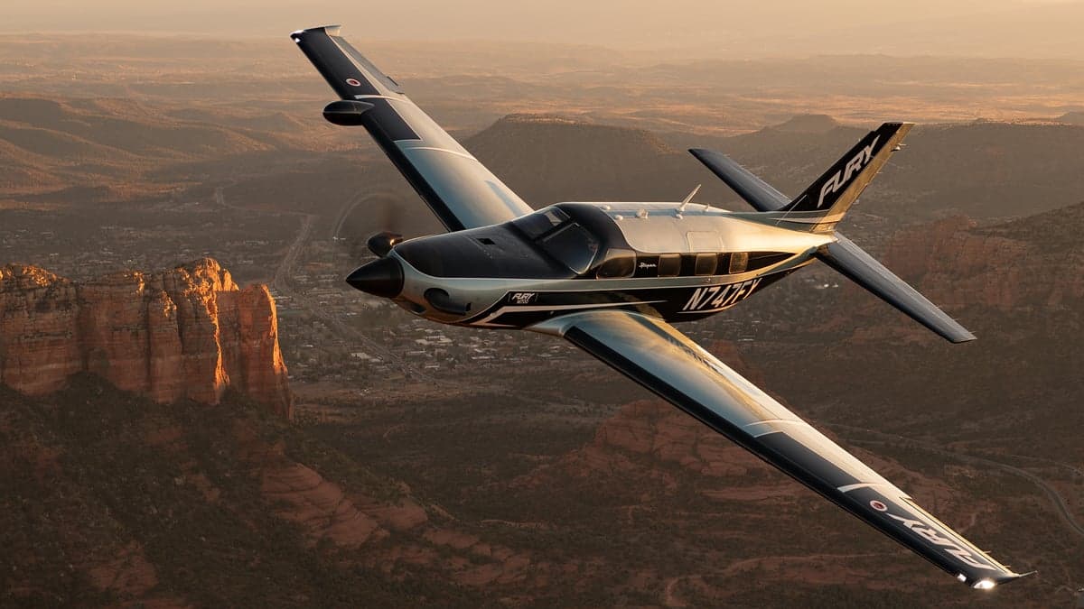A Fury aircraft flying over a desert landscape.