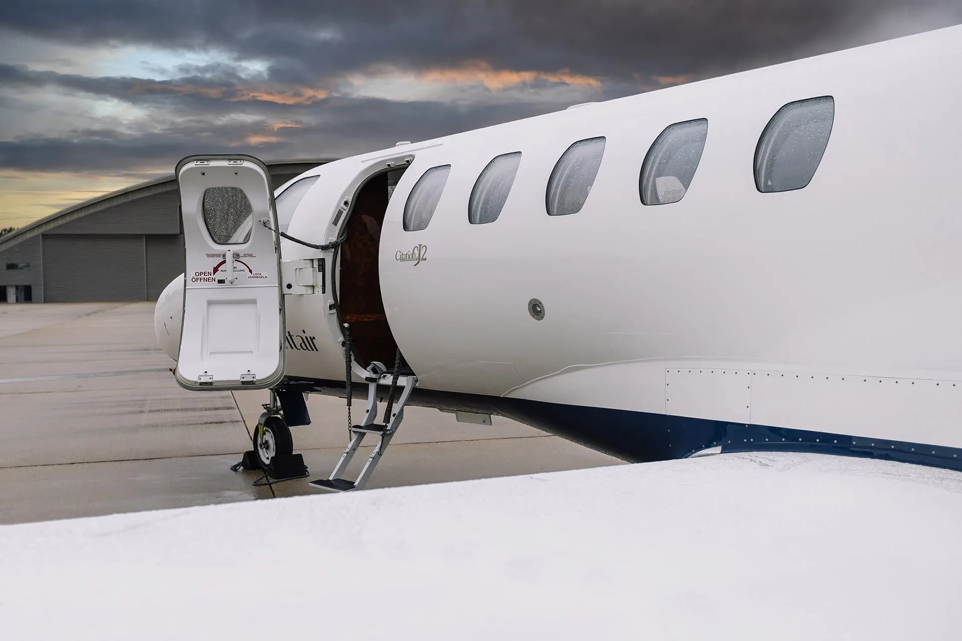 Close-up of the entry door and steps of a Cessna Citation CJ2 aircraft.