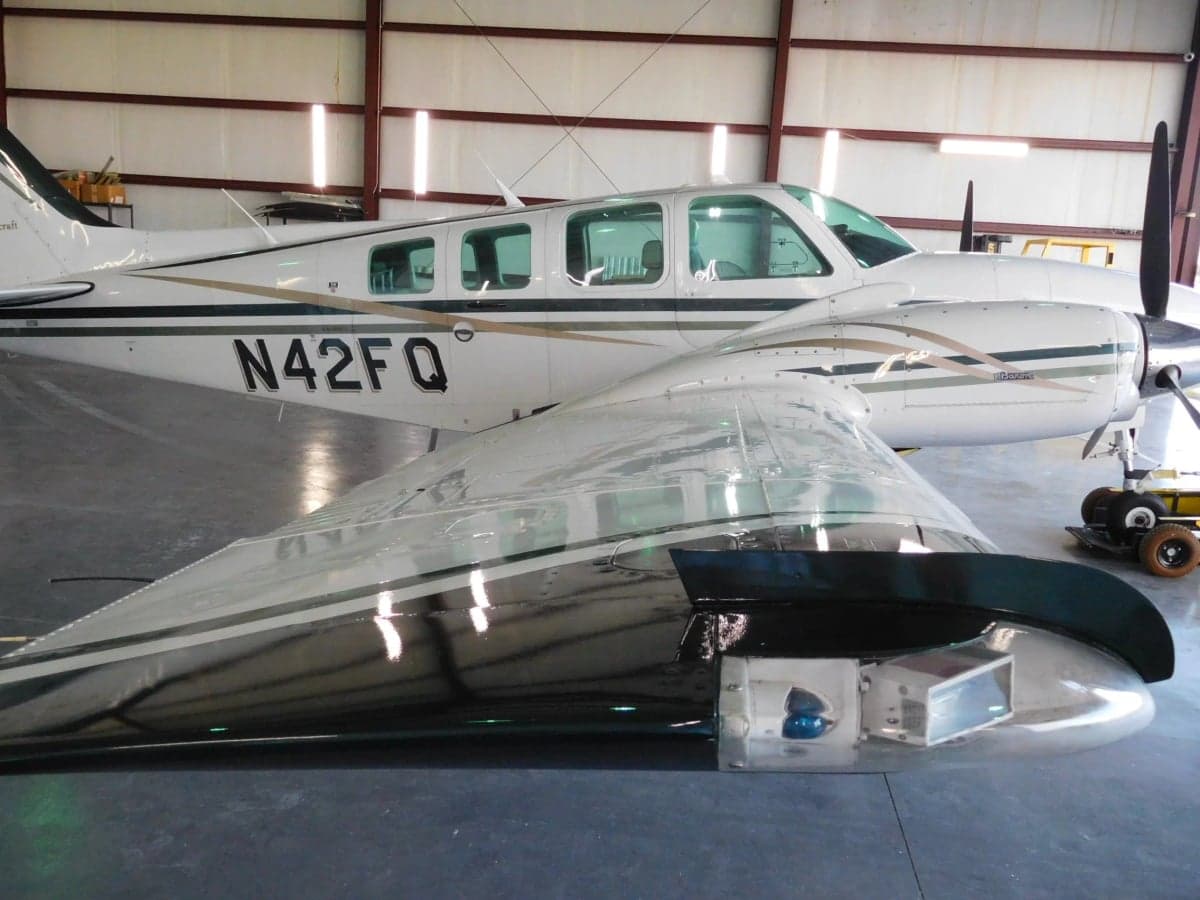 Close-up of the wing and fuselage of the Beechcraft Baron N42FQ.
