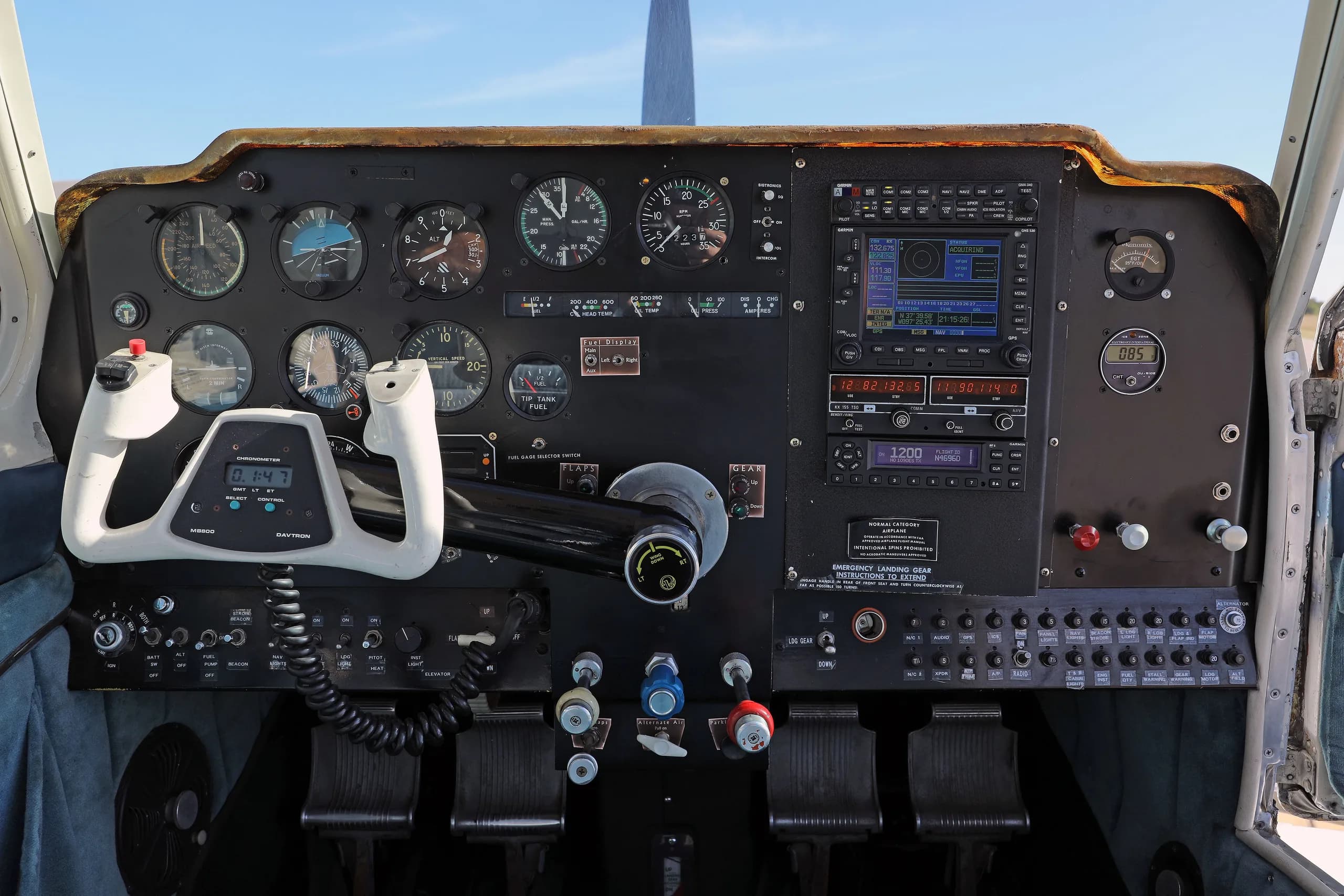 A detailed view of the instrument panel and controls in the cockpit of a small aircraft.