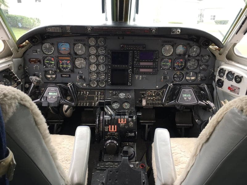 The cockpit of the Beechcraft King Air 90C, featuring a full array of instruments and controls.