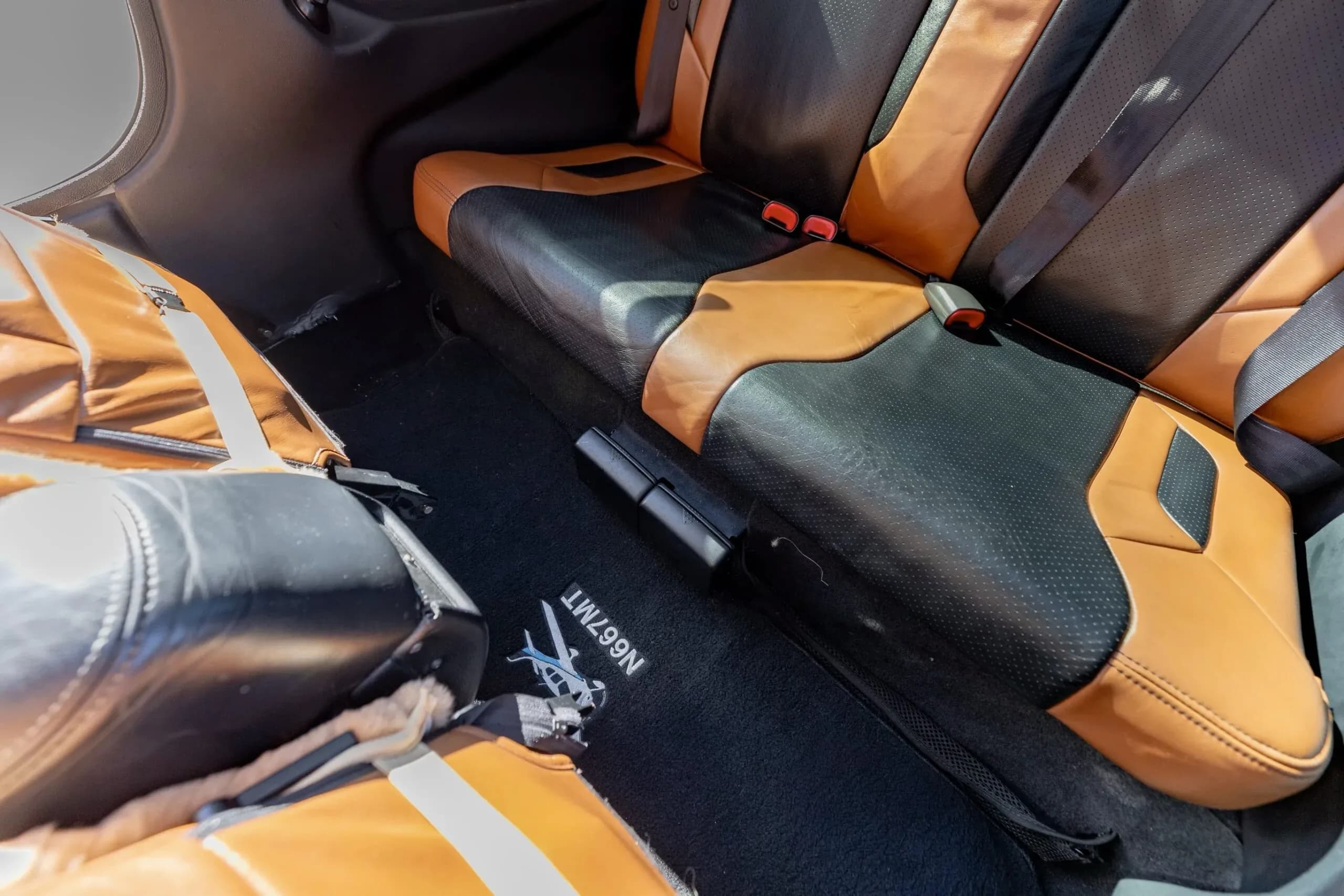 The interior floor and seats of the Cirrus SR20 GTS aircraft, showing the N667MT logo on the floor mat.
