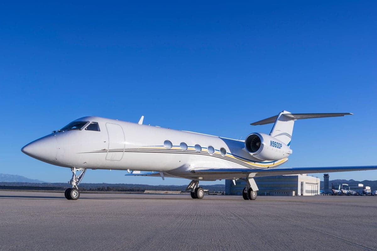 Side view of a white Gulfstream G600 on the tarmac.