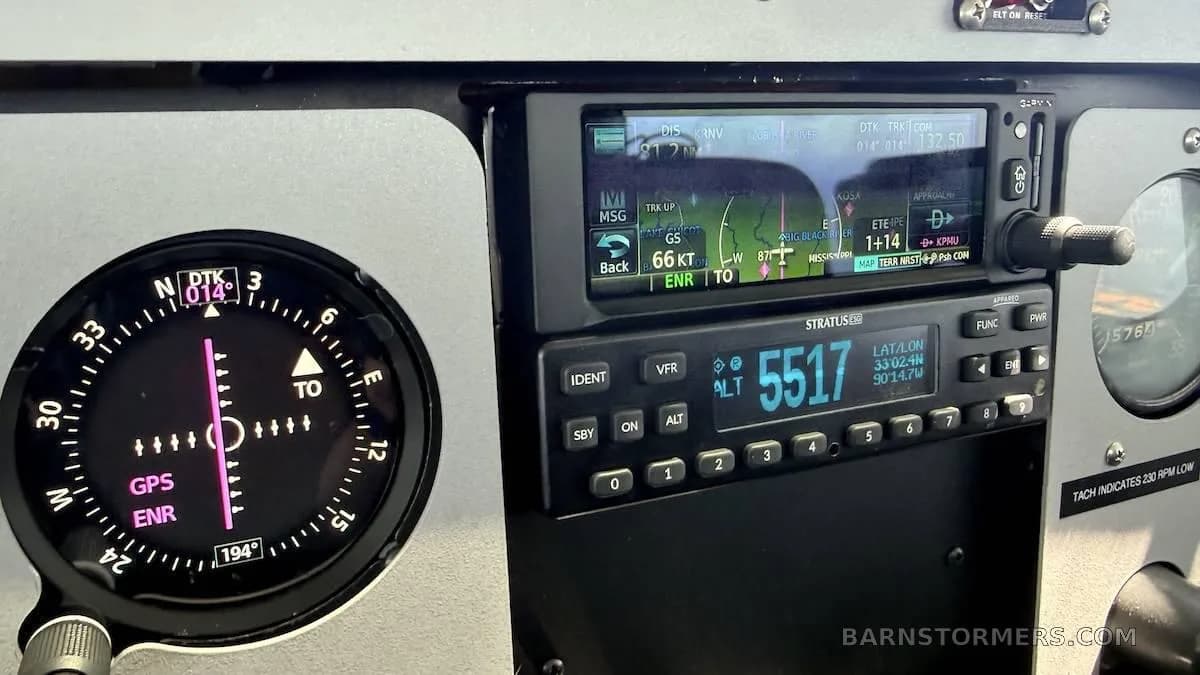 Close-up of the aircraft's instrument panel showing a GPS display and other avionics.