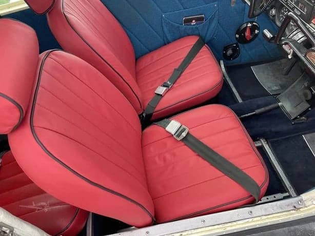 Close-up of the red leather seats inside the aircraft cabin.