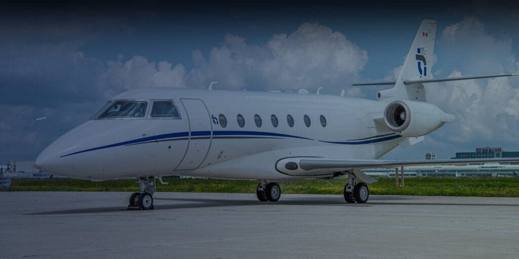 A Citation aircraft parked on the tarmac with red and blue accents.