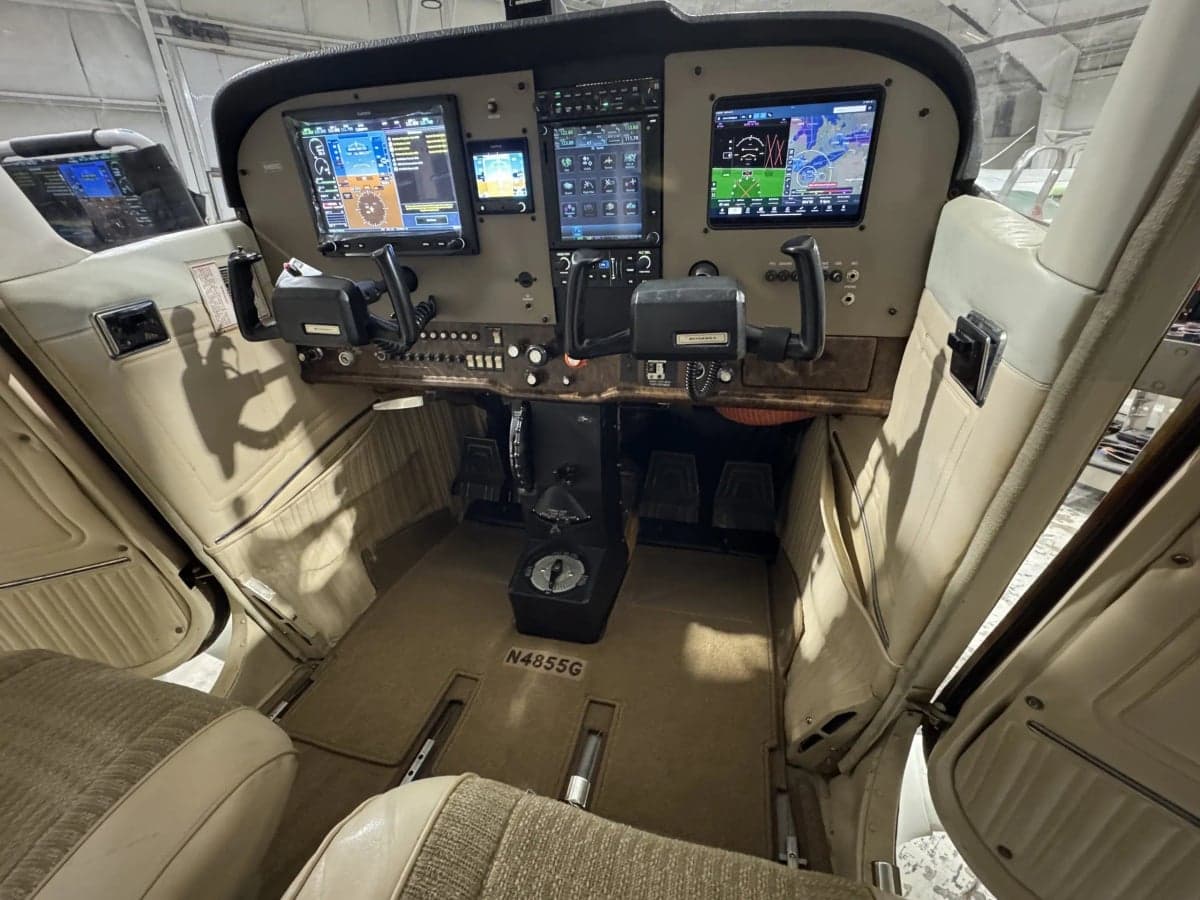 The cockpit of N4855G features modern avionics and beige interior.