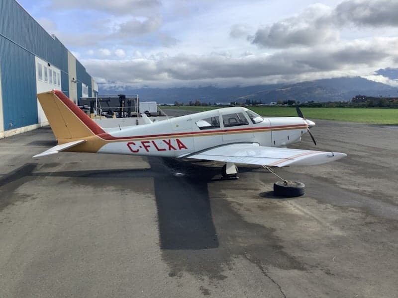 Side view of the C-FLXA aircraft parked on the tarmac.