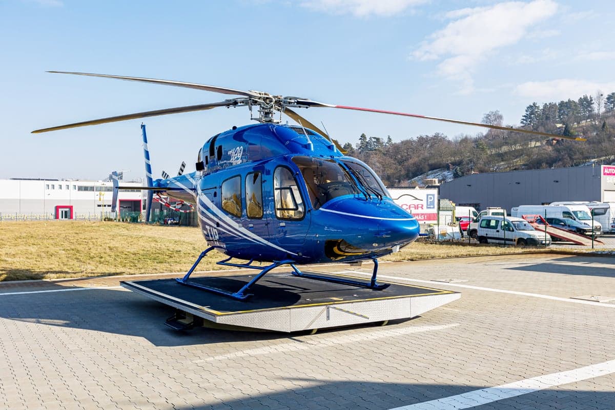 A 2012 Bell 429 helicopter with blue and white paint scheme on a platform.