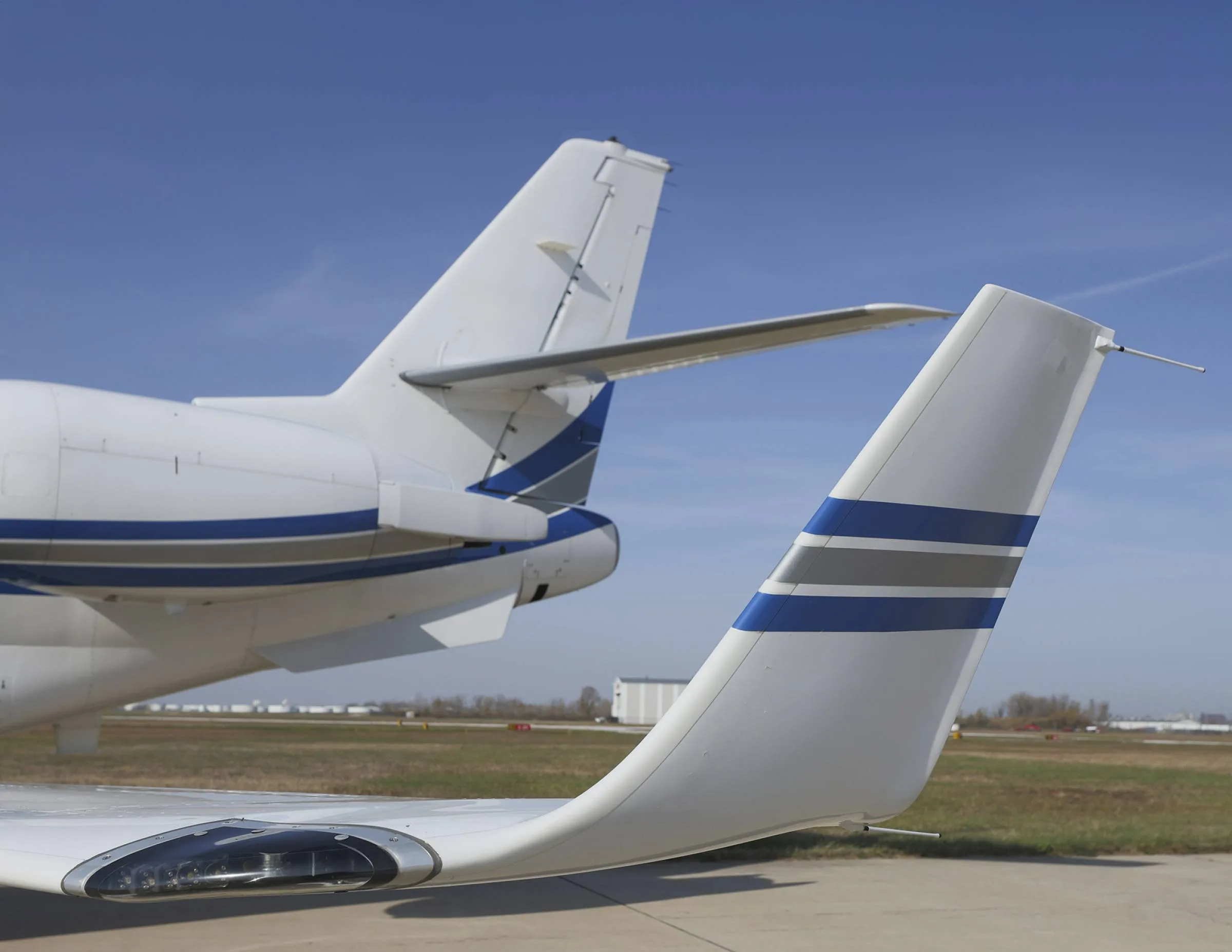 Close up of the tail of a white and blue Gulfstream jet.