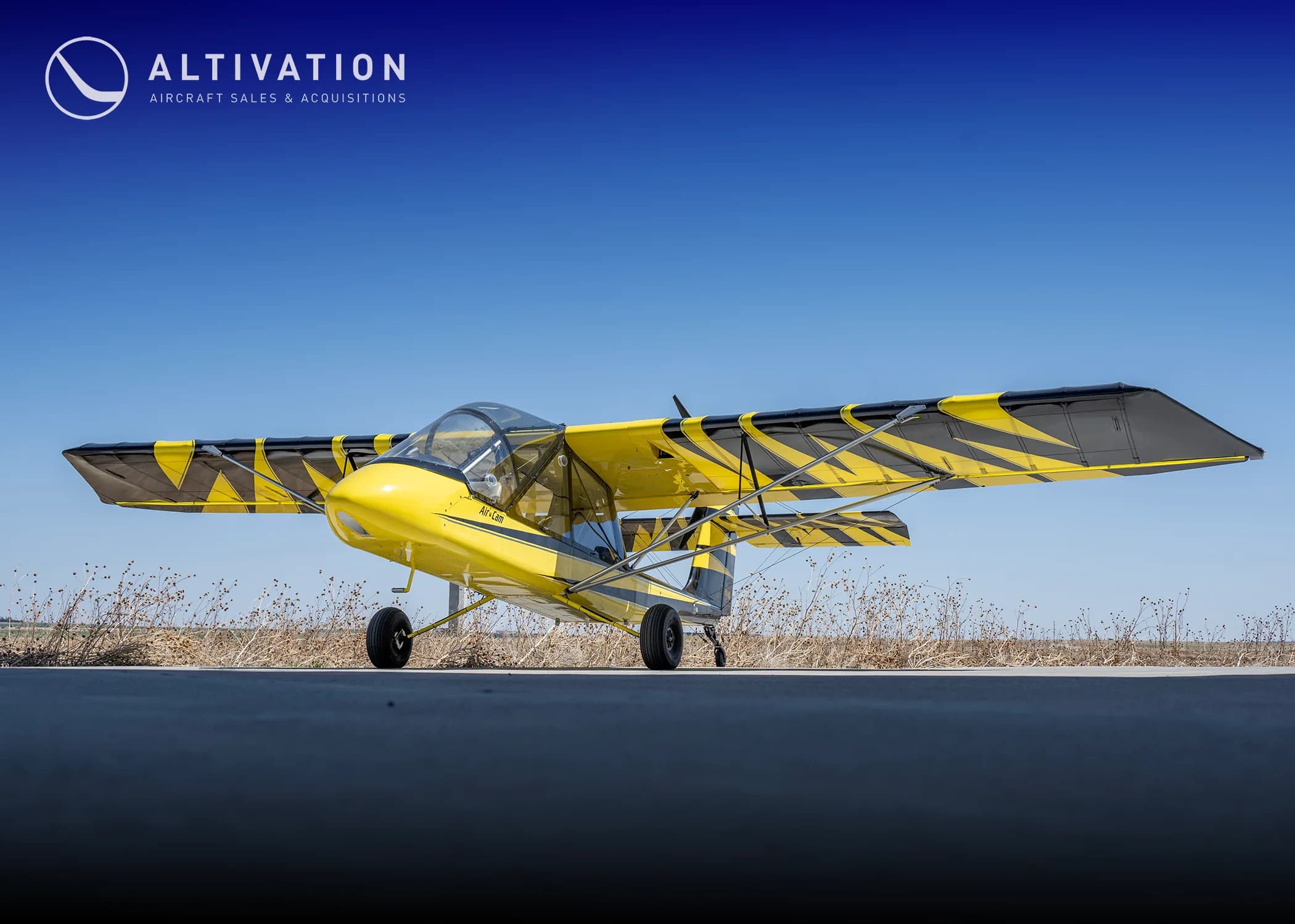 Yellow and black AirCam on the ground.