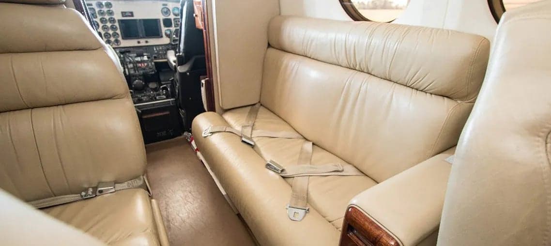 Beige leather seats inside the Beechcraft King Air 200 cabin.