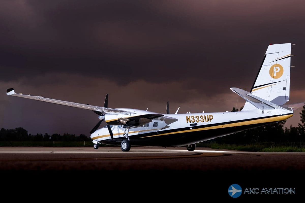 A Twin Commander aircraft with registration N333UP on the tarmac.
