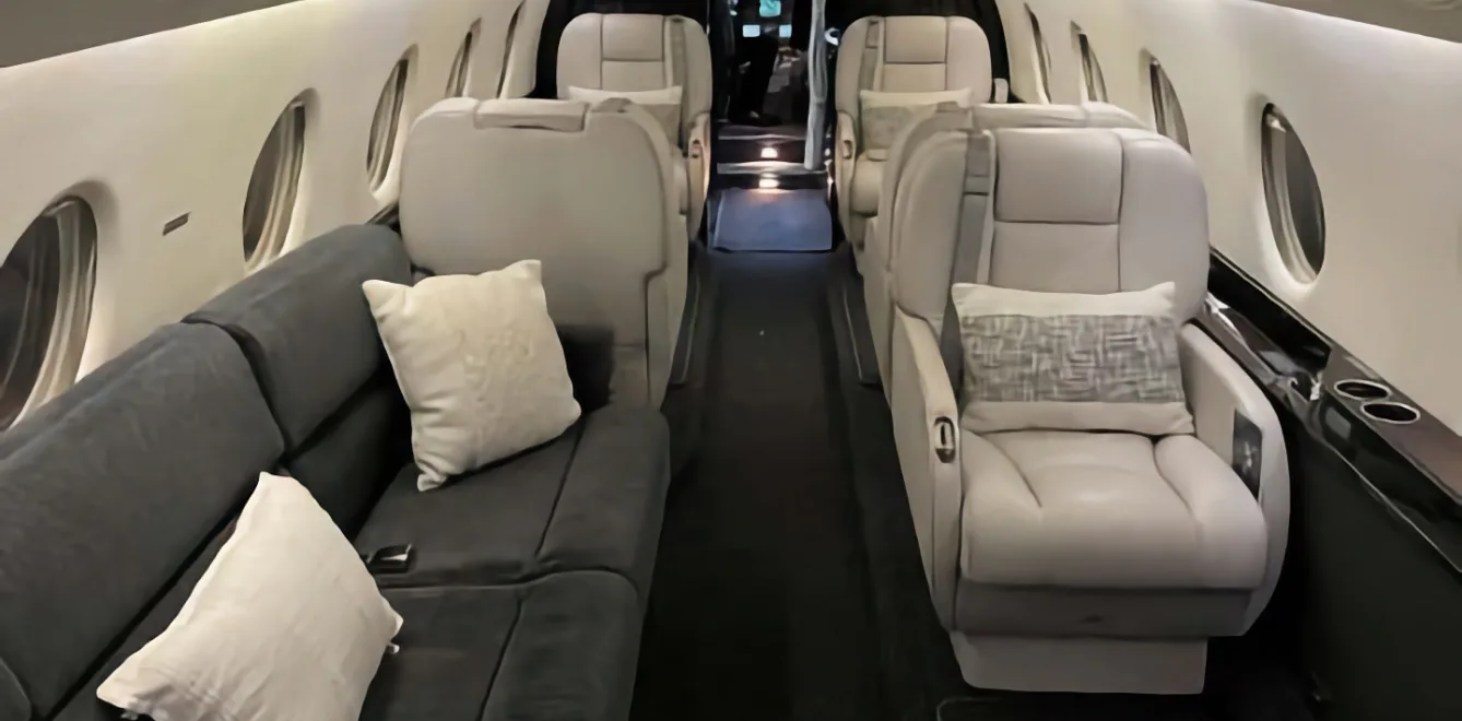 The interior of the aircraft features leather seats and a couch.
