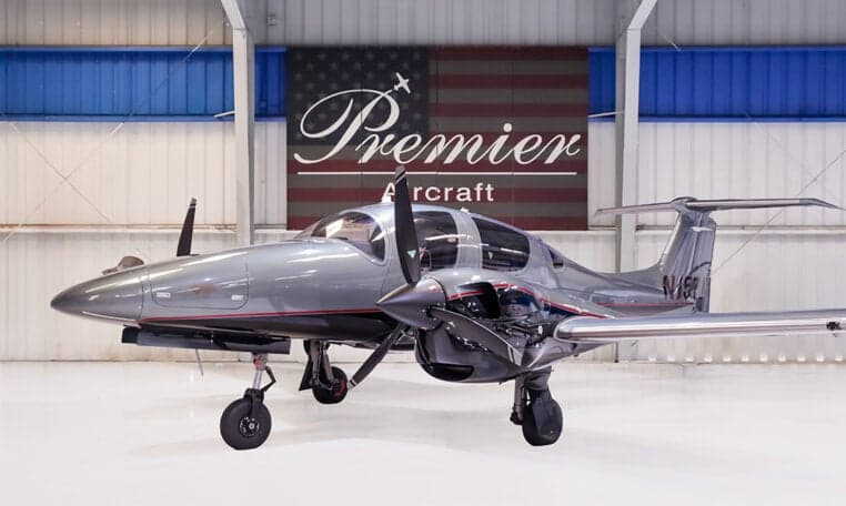 Diamond DA62 aircraft in a hangar with a gray paint scheme.
