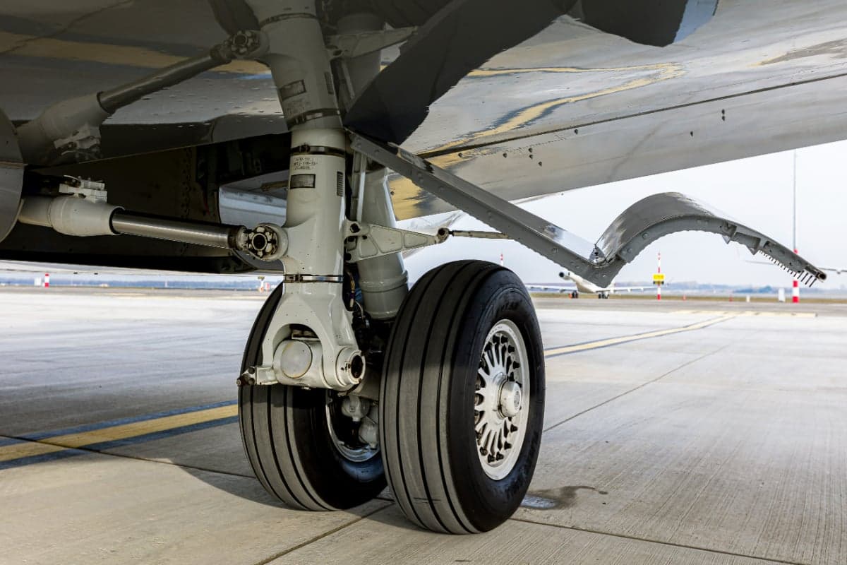 A close-up of the landing gear of the Bombardier Global 5000 aircraft 9H-ARE on the tarmac.