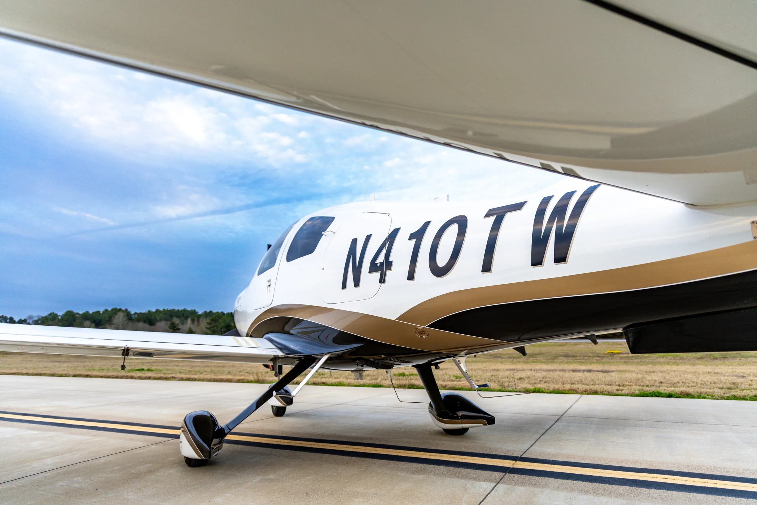Low angle view of a Cessna 400, registration N410TW, parked on the tarmac.