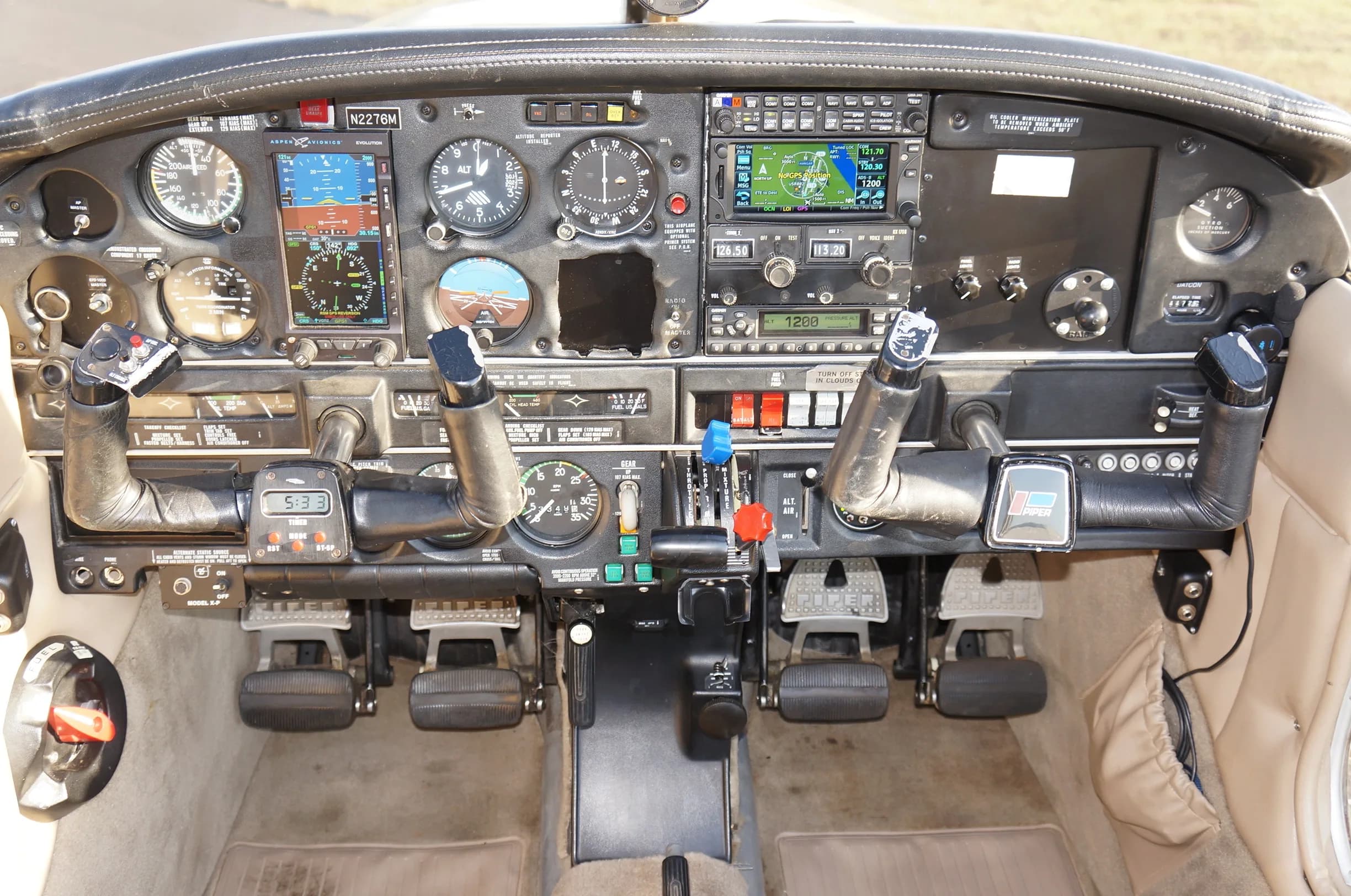 Detailed view of the aircraft's instrument panel with various gauges, screens, and controls.