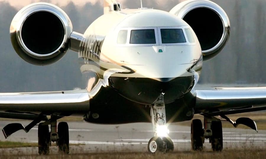 Front view of a private jet on the runway.