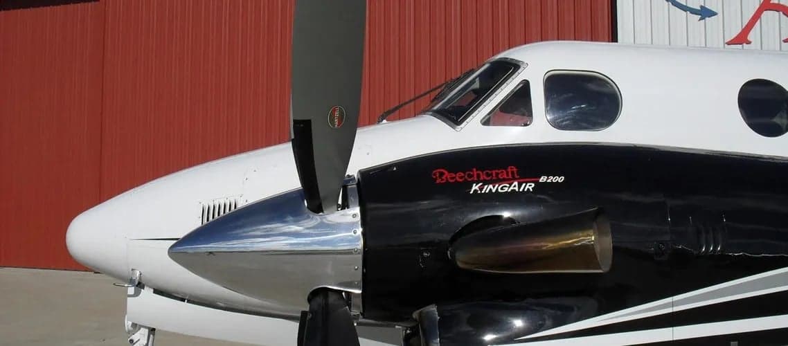 Close up of a Beechcraft King Air B200 aircraft showing the propeller and engine nacelle.