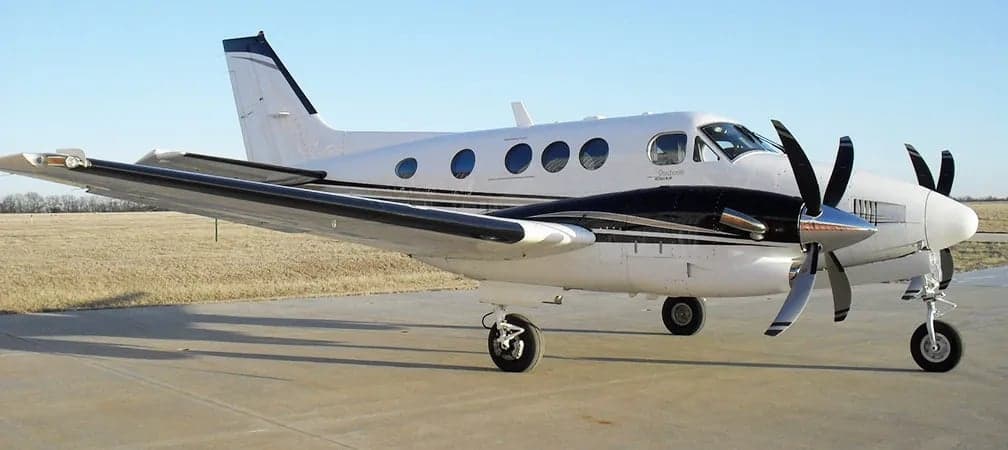A Beechcraft King Air is parked on the tarmac.