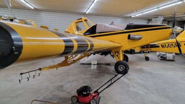 Rear view of a yellow and black aircraft with the registration number N9646A in a hangar.