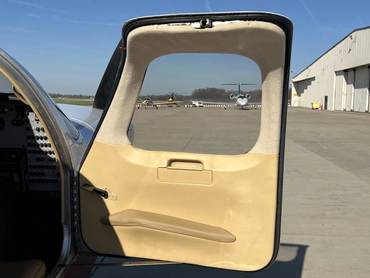 View through the open door of the cockpit and instrument panel.