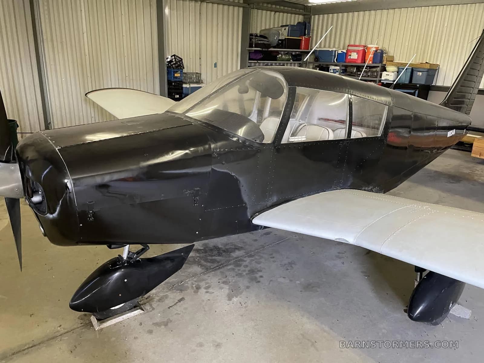 A close-up view of the aircraft's front in a hangar.