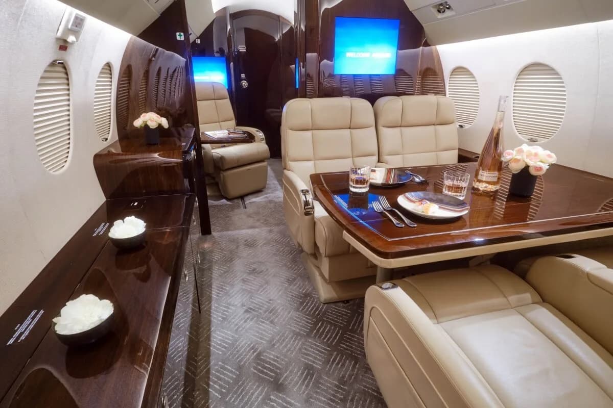View of the cabin with leather seats and a sofa.