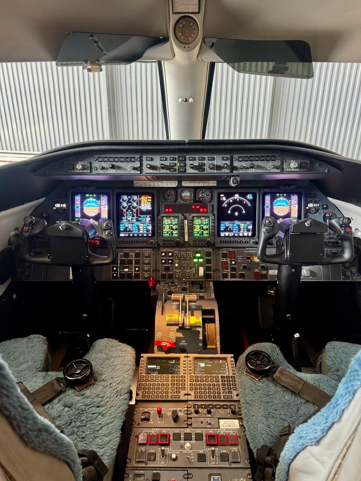 View of the Learjet 45XR cockpit with multiple displays and controls.
