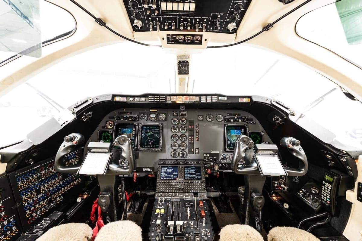 Full view of the aircraft cockpit with instrument panel and controls.