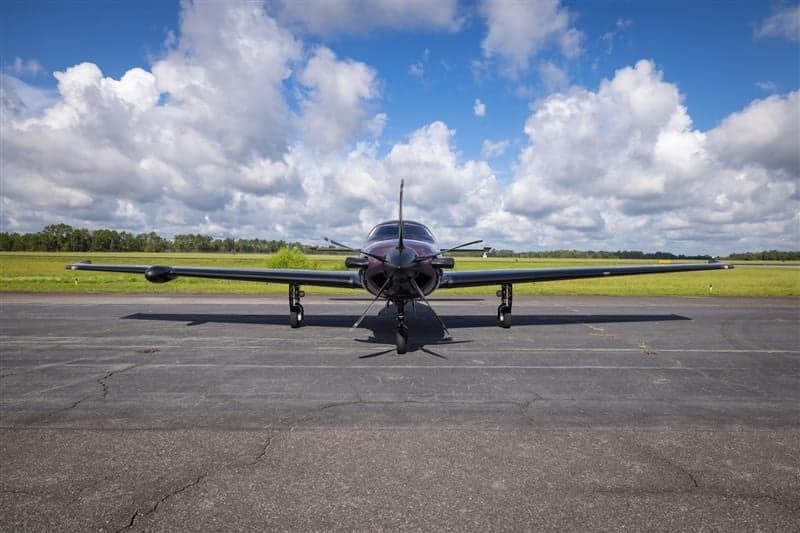 Front view of Piper M600 SLS aircraft N285KC parked on the tarmac.