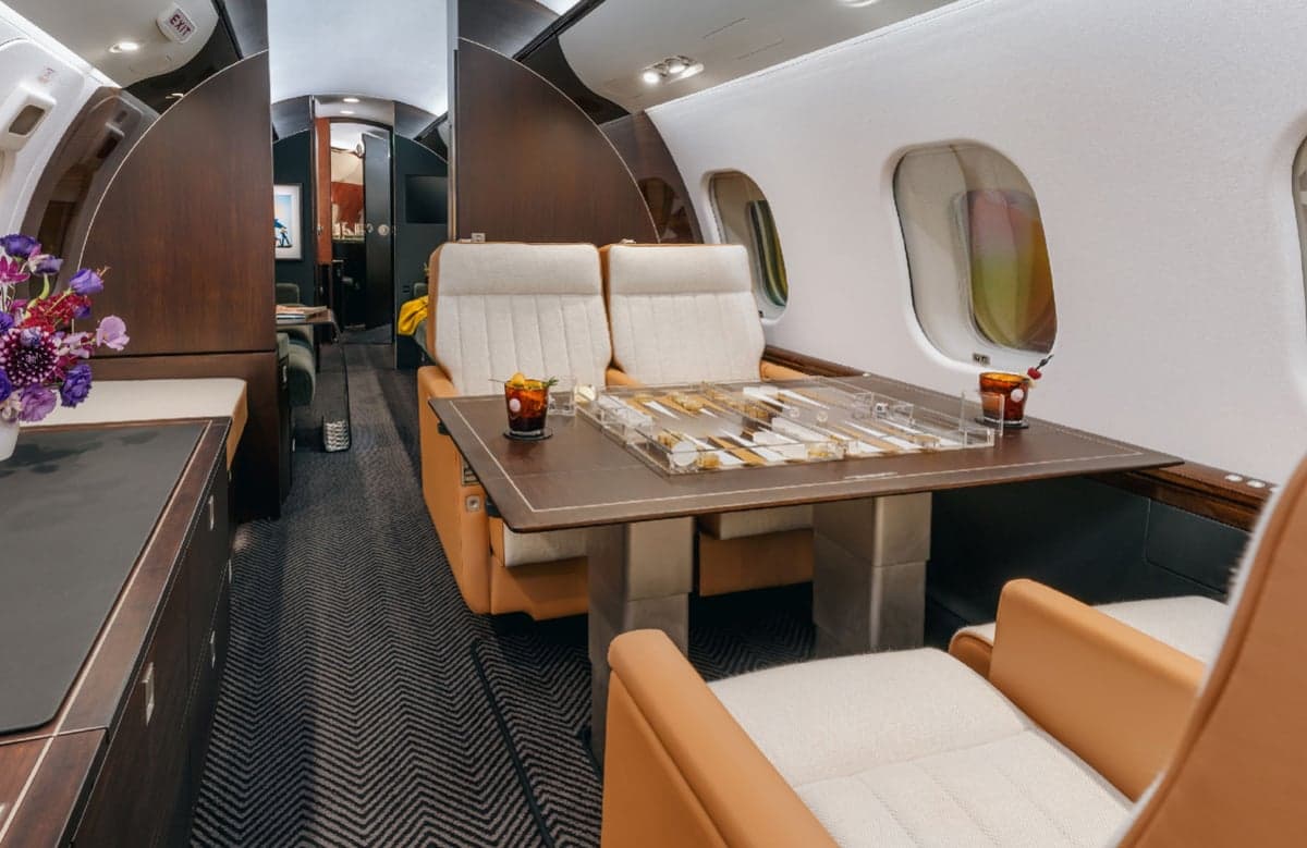 A view of the aircraft's interior with a backgammon table and seating.