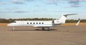 Side view of the N592GJ aircraft on the tarmac.