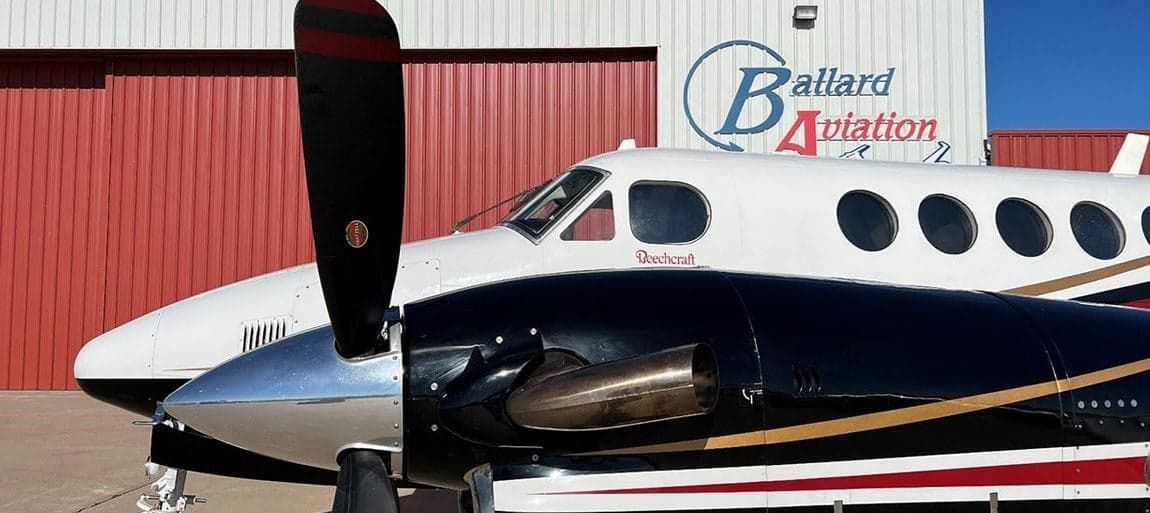 Close up of the front of a Beechcraft King Air with a black and white paint scheme.