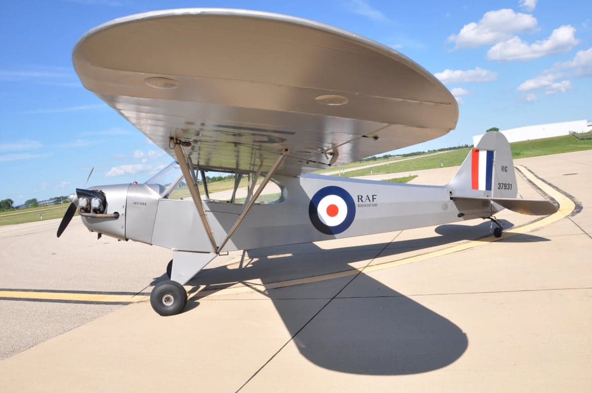 A silver Flitfire Indiana aircraft is parked on the tarmac.