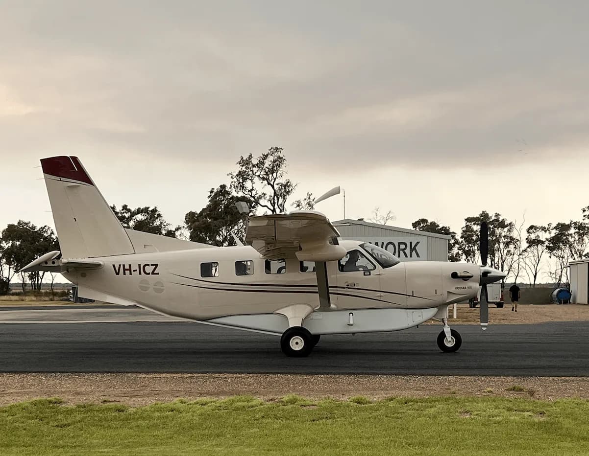 Quest Kodiak 100 on the tarmac with a beige and white paint scheme.