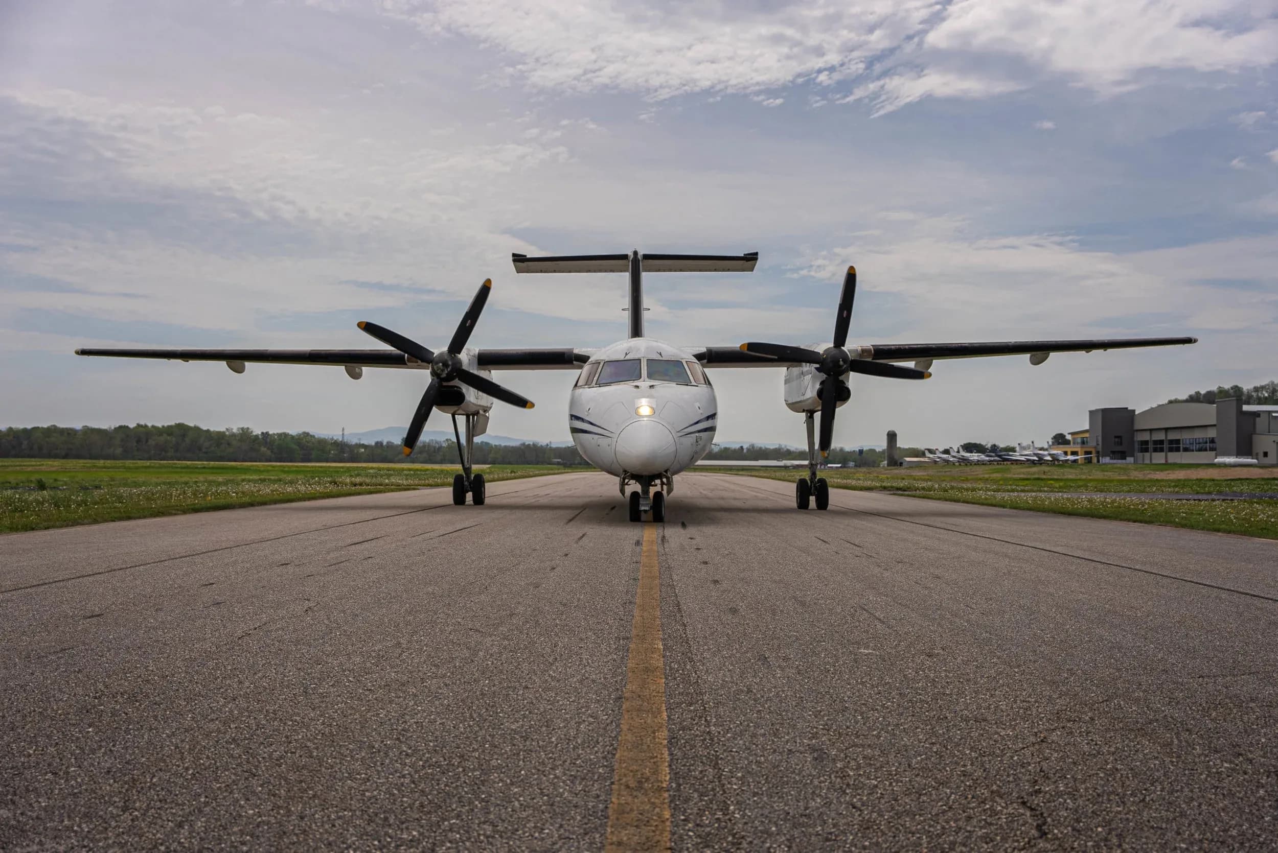 Front view of a turboprop aircraft on a runway.