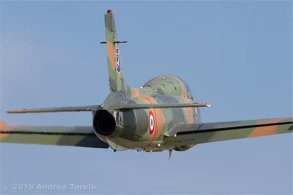 Aircraft I-MBCK in flight against a blue sky.